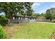 An inviting gray brick house features a lush green lawn with mature trees at 323 Amy Dr, Goose Creek, SC 29445