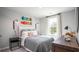 A bedroom featuring a neatly made bed, complemented by stylish wall decor and dark wood furniture at 328 Tiliwa St, Summerville, SC 29486