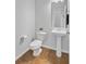 Small bathroom with sleek pedestal sink, mirror, and tiled floors at 334 Cicadas Song Dr, Moncks Corner, SC 29461