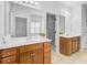 Bright bathroom featuring double sinks, a large mirror, and walk-in closets on either side, tiled floors and modern fixtures at 334 Cicadas Song Dr, Moncks Corner, SC 29461