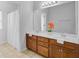 Bright bathroom featuring double sinks, a large mirror, tile flooring, and a shower with glass doors at 334 Cicadas Song Dr, Moncks Corner, SC 29461