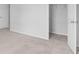 Bright bedroom showcasing neutral carpet, white trim, and access to a walk-in closet and other rooms of the home at 334 Cicadas Song Dr, Moncks Corner, SC 29461