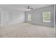 Large carpeted bedroom featuring two windows and a ceiling fan at 334 Cicadas Song Dr, Moncks Corner, SC 29461