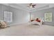 Spacious bedroom with tray ceiling, plush carpet, and large windows at 334 Cicadas Song Dr, Moncks Corner, SC 29461