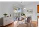 Cozy dining area featuring hardwood floors, bright walls, stylish chairs, and sliding glass door to the outside at 334 Cicadas Song Dr, Moncks Corner, SC 29461