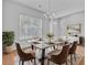 Modern dining room with seating for six, decorative chandelier, rug, and hardwood flooring at 334 Cicadas Song Dr, Moncks Corner, SC 29461
