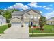 Charming two-story home with a well-maintained lawn, two car garage, and manicured landscaping at 334 Cicadas Song Dr, Moncks Corner, SC 29461