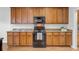 Kitchen featuring hardwood floors, black appliances, brown cabinets and granite countertops at 334 Cicadas Song Dr, Moncks Corner, SC 29461
