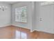 Bright, vacant room with hardwood floors, a front door, and large windows for natural light at 334 Cicadas Song Dr, Moncks Corner, SC 29461