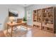 Well-lit home office space with a desk, bookshelves, and a large window at 334 Cicadas Song Dr, Moncks Corner, SC 29461