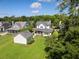 Aerial view of a charming home with a detached garage and lush green surroundings at 3426 Acorn Drop Ln, Johns Island, SC 29455