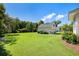 Well-maintained backyard with lush lawn leading to a detached garage at 3426 Acorn Drop Ln, Johns Island, SC 29455