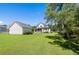Spacious backyard featuring a well-maintained lawn and detached garage at 3426 Acorn Drop Ln, Johns Island, SC 29455