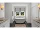 Luxurious bathroom features a standalone tub, granite countertops, and ample natural light at 3426 Acorn Drop Ln, Johns Island, SC 29455