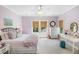 Bright, airy bedroom with neutral carpet, two windows, and soft lilac walls, creating a calm and restful space at 3426 Acorn Drop Ln, Johns Island, SC 29455