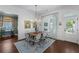 Charming dining room featuring a wood table, elegant chandelier, and bright natural light at 3426 Acorn Drop Ln, Johns Island, SC 29455