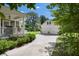 Long driveway leading to a detached garage and home with a charming front porch at 3426 Acorn Drop Ln, Johns Island, SC 29455