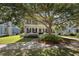 Charming two-story home features a double porch, lush landscaping, and a walkway to the front door at 3426 Acorn Drop Ln, Johns Island, SC 29455