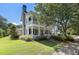 Charming two-story home features a double porch, manicured landscaping, and lovely curb appeal at 3426 Acorn Drop Ln, Johns Island, SC 29455