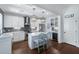 A modern kitchen features white cabinets, stainless steel appliances, and an island with seating at 3426 Acorn Drop Ln, Johns Island, SC 29455