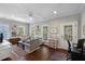 Inviting living room with hardwood floors, neutral walls, and plush seating, creating a comfortable and stylish space at 3426 Acorn Drop Ln, Johns Island, SC 29455