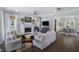 Bright living room with fireplace, ceiling fan, hardwood floors, and access to the dining area at 3426 Acorn Drop Ln, Johns Island, SC 29455