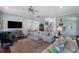 Bright living room with fireplace, ceiling fan, hardwood floors, and access to the staircase at 3426 Acorn Drop Ln, Johns Island, SC 29455