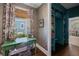 A small office area features a desk, patterned wallpaper, and access to built-in bookshelves at 3426 Acorn Drop Ln, Johns Island, SC 29455