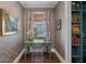 A cozy office space with unique wallpaper, a green desk, and natural light from the window at 3426 Acorn Drop Ln, Johns Island, SC 29455