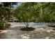 A community pool with several lounge chairs underneath a covered shelter and a small tree in the middle at 3426 Acorn Drop Ln, Johns Island, SC 29455
