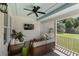 Relaxing screened porch with wood furniture, ceiling fan, and views of the lush backyard at 3426 Acorn Drop Ln, Johns Island, SC 29455