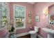 Charming powder room with pink walls, decorative mirror, and a window offering a serene view at 3426 Acorn Drop Ln, Johns Island, SC 29455