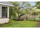 Backyard featuring a brick fire pit with seating, a swing set, lush landscaping, and mature trees at 36 Nicholson St, Charleston, SC 29407