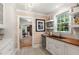Charming bar area featuring a mini-fridge, wooden countertop, open shelving, and decorative chandelier at 36 Nicholson St, Charleston, SC 29407