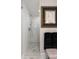 Elegant walk-in shower features white subway tile and mosaic tile flooring, complemented by stylish artwork and dark towels at 36 Nicholson St, Charleston, SC 29407