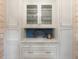 Elegant white built-in cabinetry with glass doors, marble countertop and designer hardware at 36 Nicholson St, Charleston, SC 29407
