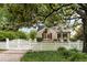A well-maintained brick home is framed by mature trees and a white picket fence at 36 Nicholson St, Charleston, SC 29407