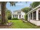 Charming two-story white home with a lush front yard and screened in porch at 36 Nicholson St, Charleston, SC 29407