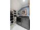 Well-organized laundry room with front-load washer and dryer, shelving, and artwork at 36 Nicholson St, Charleston, SC 29407