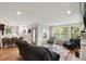 Open-concept living room flows into the kitchen with wood floors and lots of natural light at 36 Nicholson St, Charleston, SC 29407