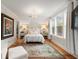Charming main bedroom with hardwood floors, chandelier, and ample natural light at 36 Nicholson St, Charleston, SC 29407