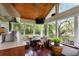 Inviting outdoor kitchen/porch with built-in grill, wood ceiling, and views of the lush backyard at 36 Nicholson St, Charleston, SC 29407