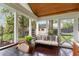 Relaxing outdoor porch with seating, decorative pillows, and views of the backyard and play area at 36 Nicholson St, Charleston, SC 29407
