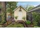 Playful backyard shed with decorative details and lush landscaping and a play area at 36 Nicholson St, Charleston, SC 29407
