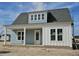 Charming single-story home showcasing a welcoming porch, light blue siding, and white trim under a gray shingled roof at 363 Trailmore Ln, Summerville, SC 29486