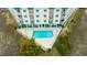 Aerial view of a condo's triangle pool surrounded by lush greenery and trees at 3701 Docksite Rd # 220, Edisto Island, SC 29438