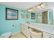 Bright bathroom featuring a vanity, large mirror, and vanity seating, providing ample space at 3701 Docksite Rd # 220, Edisto Island, SC 29438