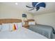 Inviting bedroom with two beds, complemented by a unique ceiling fan and nautical decor at 3701 Docksite Rd # 220, Edisto Island, SC 29438