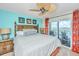 Tranquil bedroom featuring a ceiling fan, balcony access, and soothing decor with coastal colors and accents at 3701 Docksite Rd # 220, Edisto Island, SC 29438