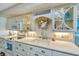 This kitchen features white cabinetry and stainless steel appliances at 3701 Docksite Rd # 220, Edisto Island, SC 29438
